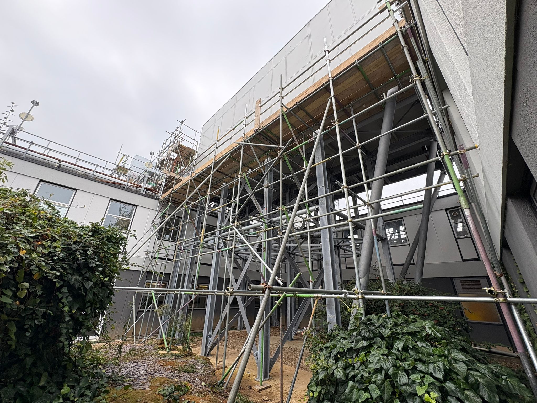 Industrial scaffolding system providing access to plant works in a warehouse courtyard